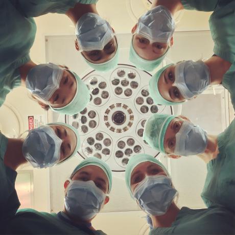 Surgeons around a patient in an operation table from the patient's POV