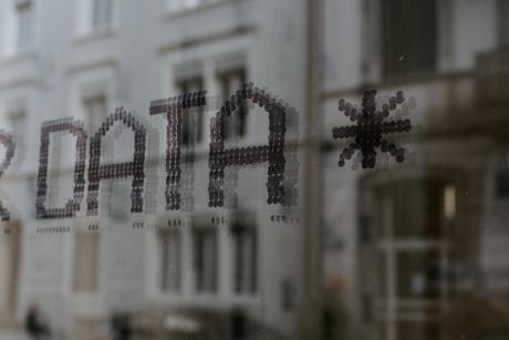 A building with the letters DATA projected on it using some light source